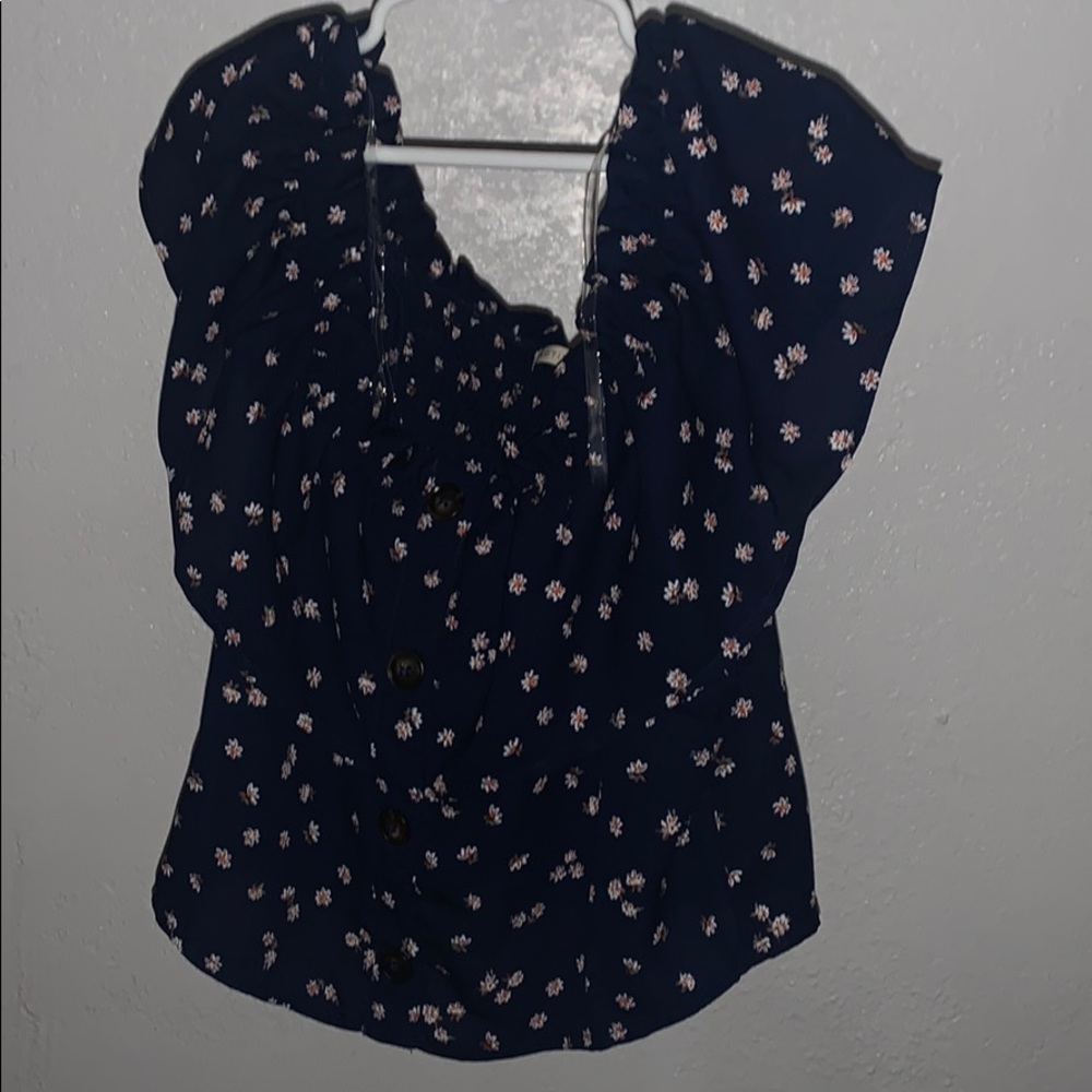 blue shirt with white flowers on it